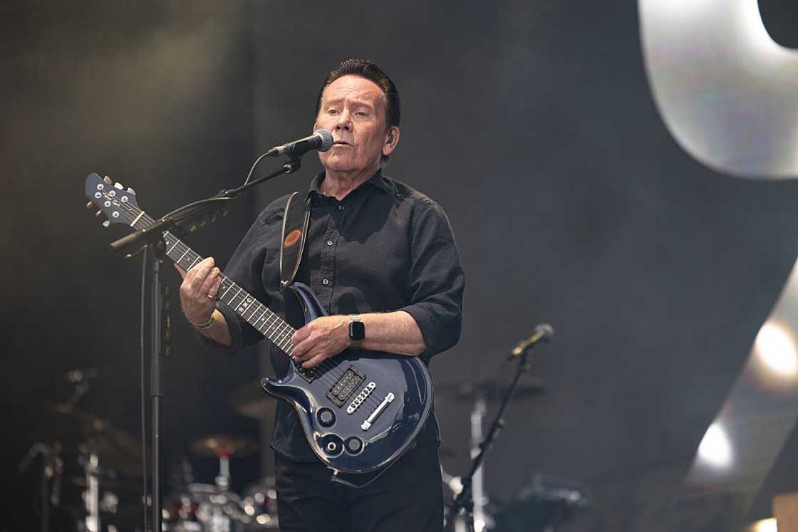 Robin Campbell sings and plays the guitar at a concert Robin Campbell sings and plays the guitar at a concert