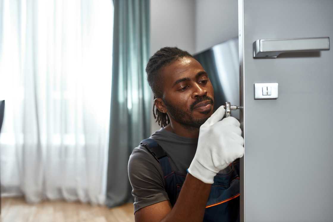 A locksmith fixing the door A locksmith fixing the door