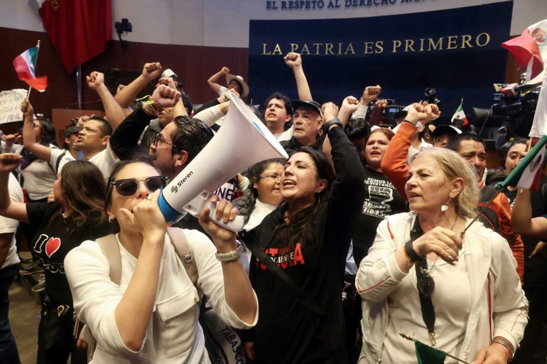 Demonstrators are seen inside Mexico's Senate after storming the building on September 10 to disrupt a debate on controversial judicial reforms