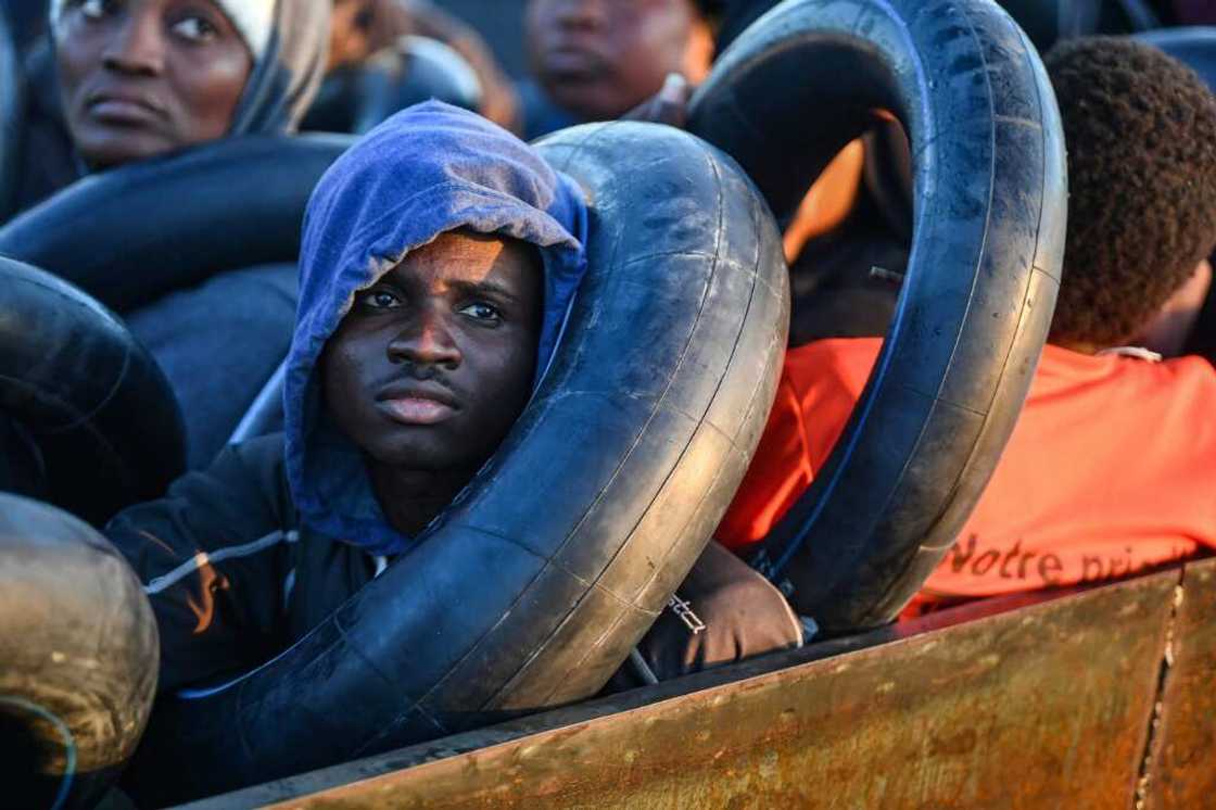 Migrants clutch the inner tubes of truck tyres, their sole protection in the event of shipwreck on the perilous sea crossing Migrants clutch the inner tubes of truck tyres, their sole protection in the event of shipwreck on the perilous sea crossing