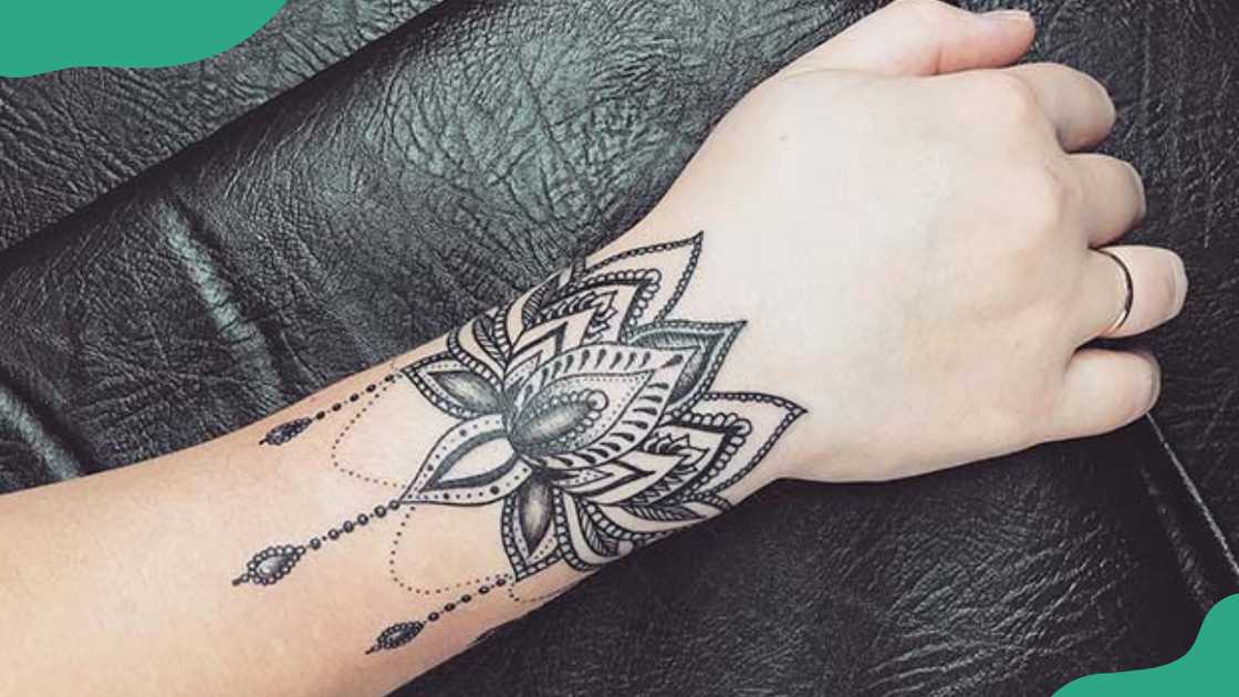 Ornamental lotus bracelet tattoo