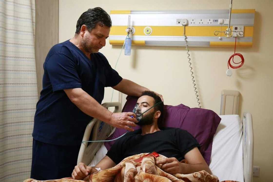 A medic helps a man suffering from breathing difficulties after inhaling chlorine gas during Monday's leak in the Jordanian port of Aqaba