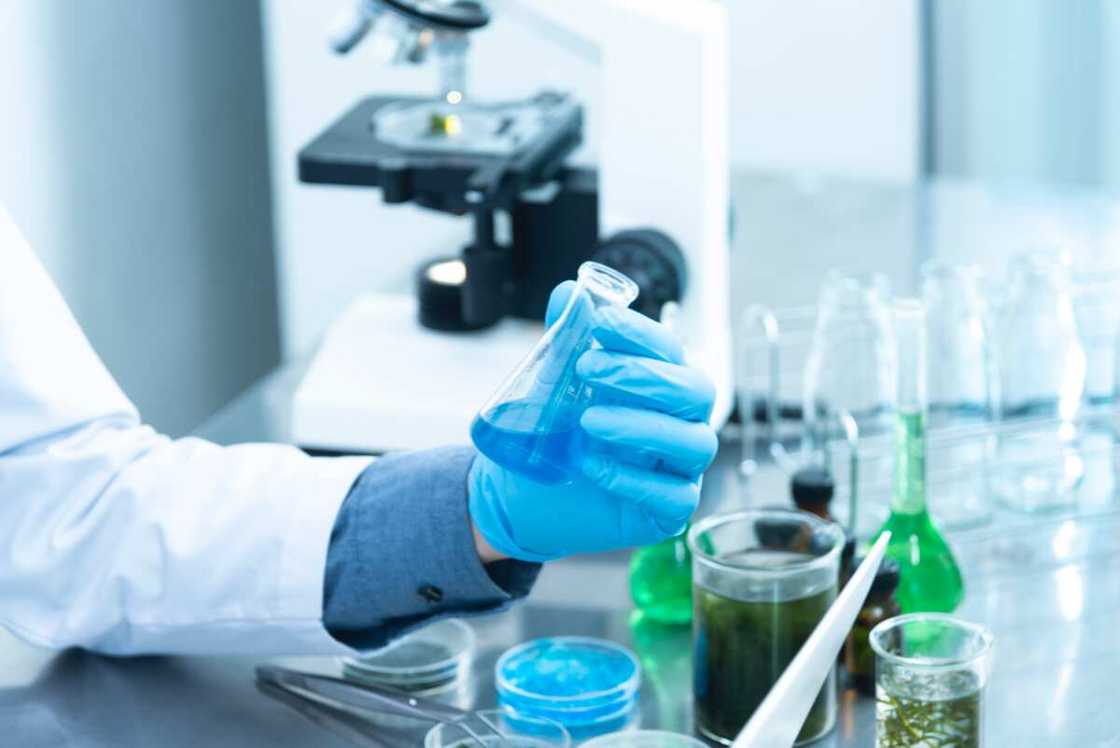 A student holding a laboratory flask