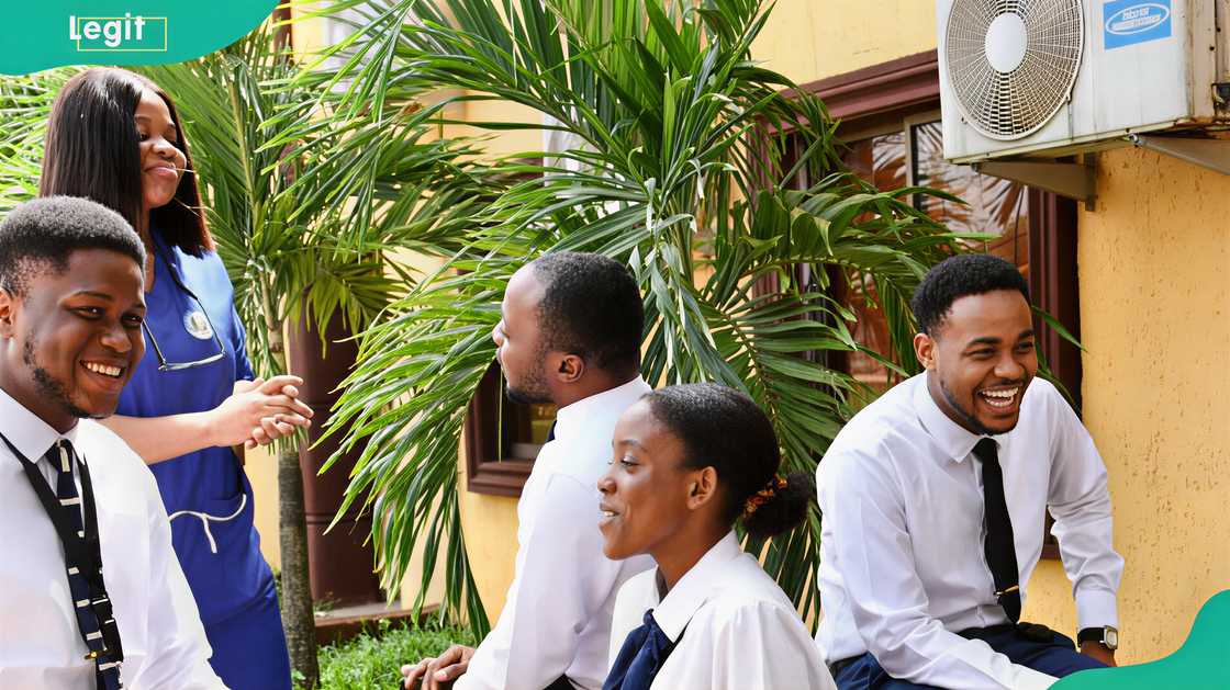 Benson Idahosa University students relaxing outside the university compound