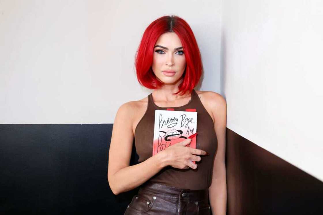 Megan Fox poses for a photo with her book Megan Fox poses for a photo with her book