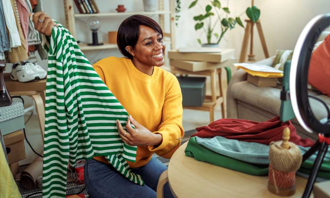 A woman selling her clothes online A woman selling her clothes online