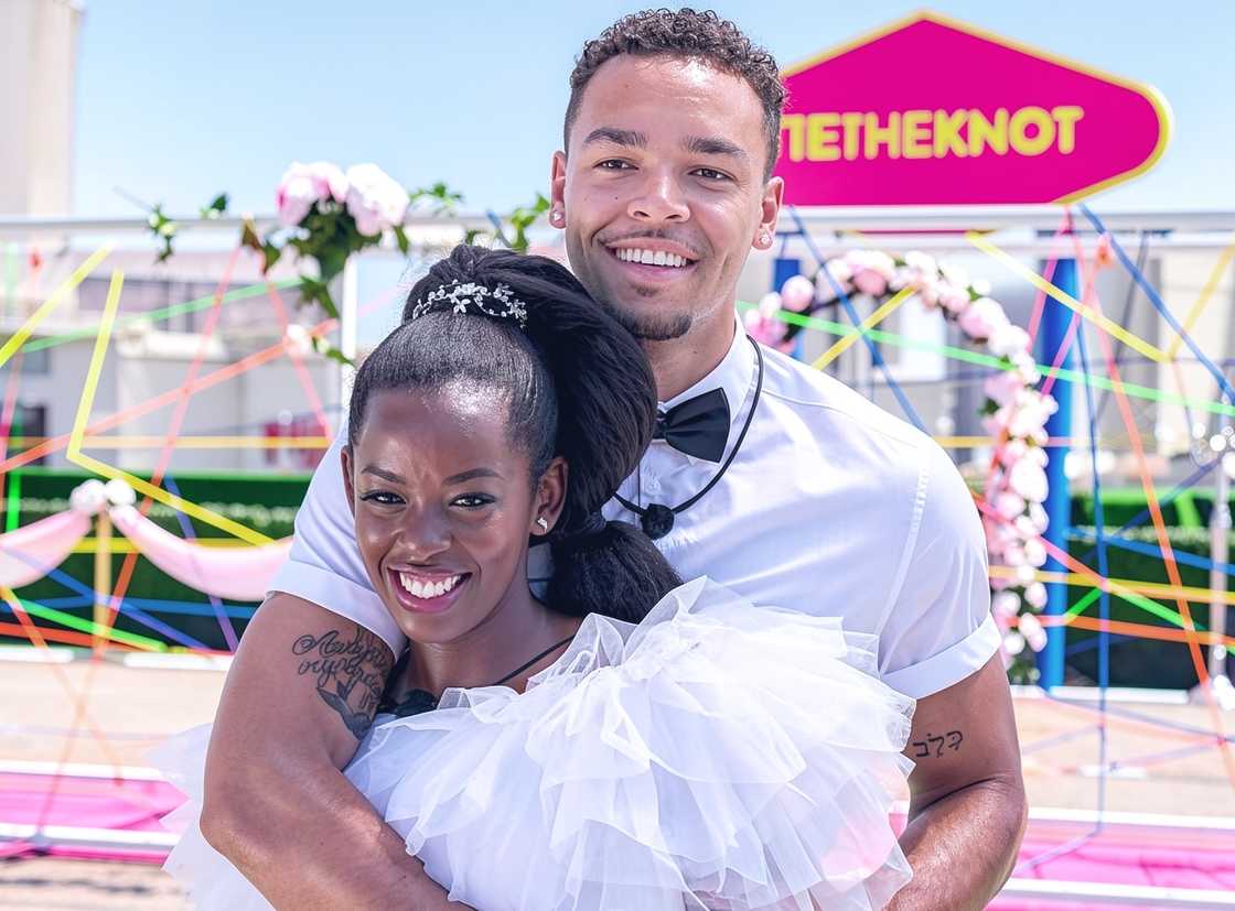 Caleb Corprew poses with his arms around Justine Ndiba