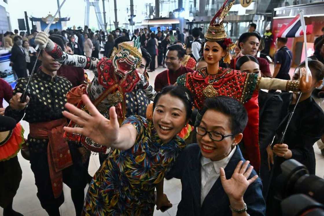 Chinese tourists are greeted by Thai dancers at Suvarnabhumi International Airport in Bangkok Chinese tourists are greeted by Thai dancers at Suvarnabhumi International Airport in Bangkok