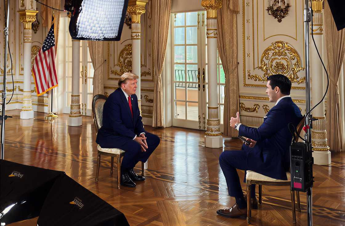Rob Schmitt gestures as he speaks with US president, Donald Trump