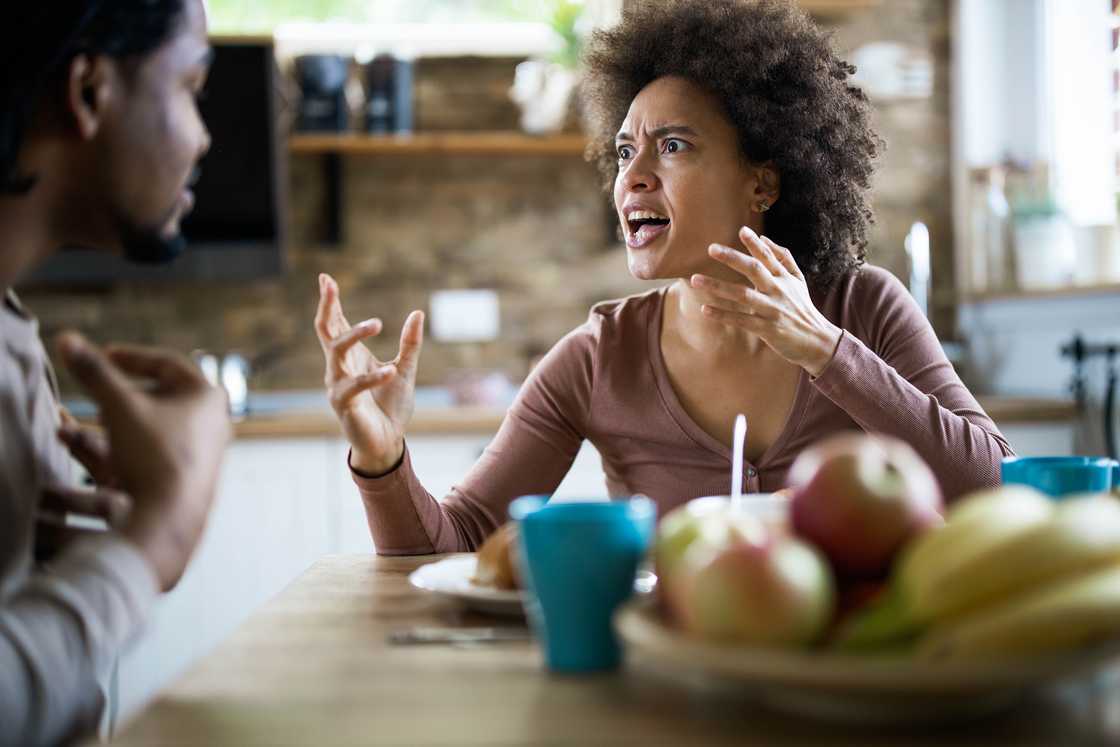 A couple arguing while having a meal A couple arguing while having a meal