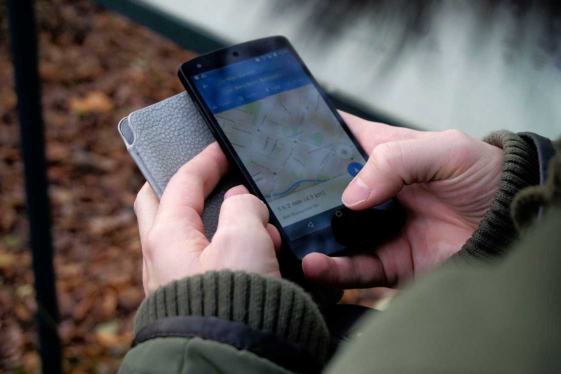 A person using Google Maps on a smartphone A person using Google Maps on a smartphone