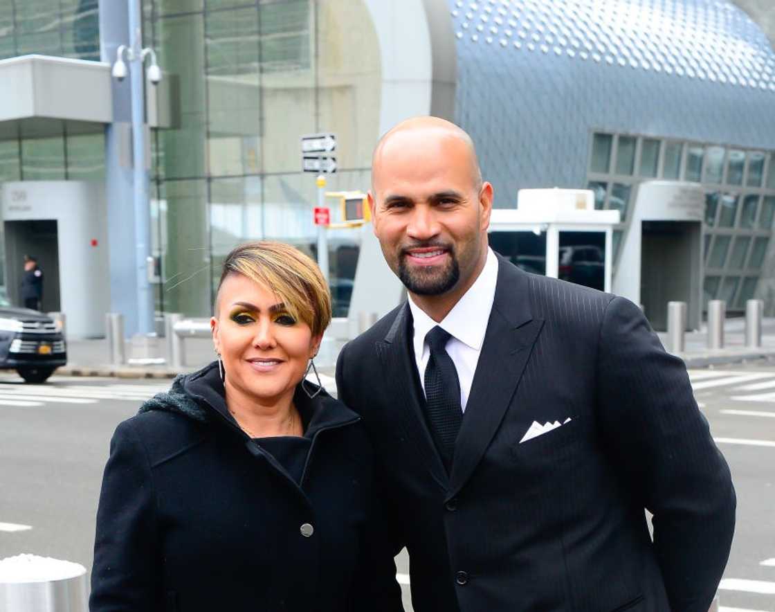 Deidre Pujols and Albert Pujols posing for a photo outside the United Nations