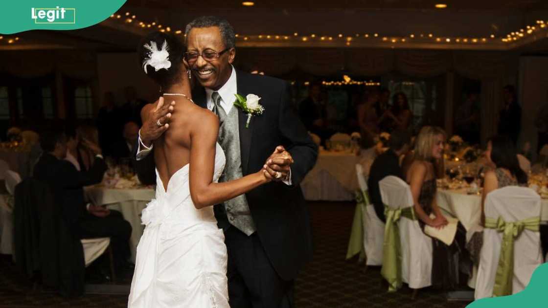 A bride and father dancing at wedding reception A bride and father dancing at wedding reception