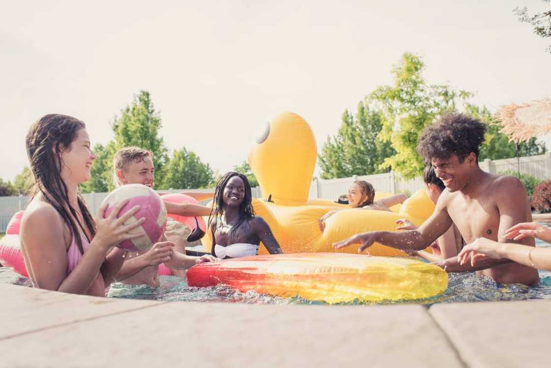 Group of teenagers playing in a pool