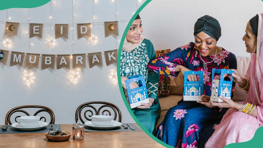 A table set up with Eid Mubarak decorations on the wall and three women in hijabs opening their Eid presents