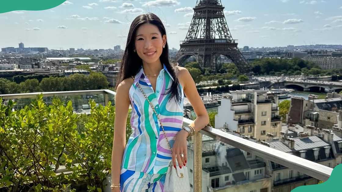 Rebecca Ma poses on top of a building