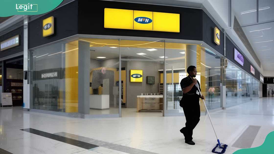 A person cleaning outside MTN bank premises