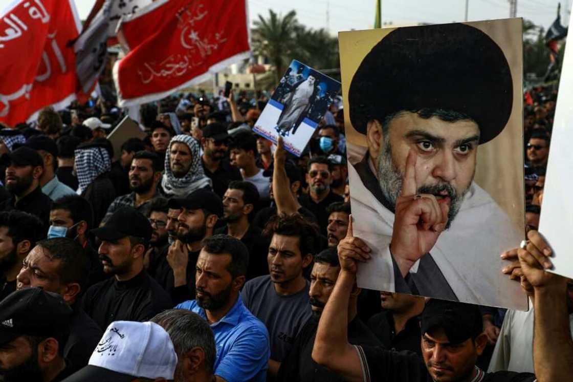 Supporters of Shiite cleric Moqtada Sadr carry portraits of him as they gather in the southern Iraqi city of Nasiriyah Supporters of Shiite cleric Moqtada Sadr carry portraits of him as they gather in the southern Iraqi city of Nasiriyah
