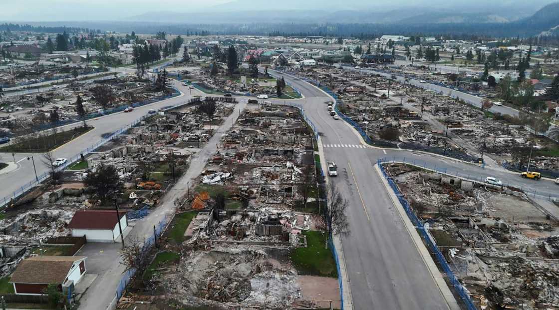 This handout videograb provided by Park Canada shows the devastated town of Jasper following a wildfire in August 2024 that burned more than 350 of the 1,100 buildings in the town This handout videograb provided by Park Canada shows the devastated town of Jasper following a wildfire in August 2024 that burned more than 350 of the 1,100 buildings in the town