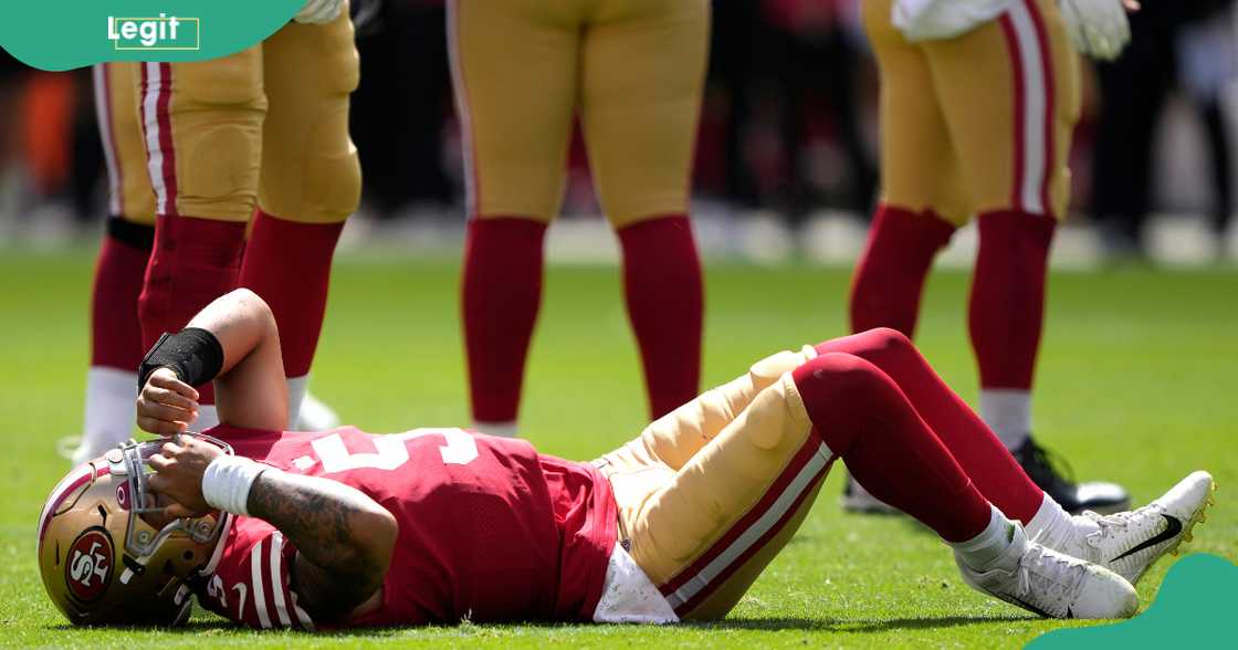 Trey Lance of the San Francisco 49ers lays on the ground after an apparent injury