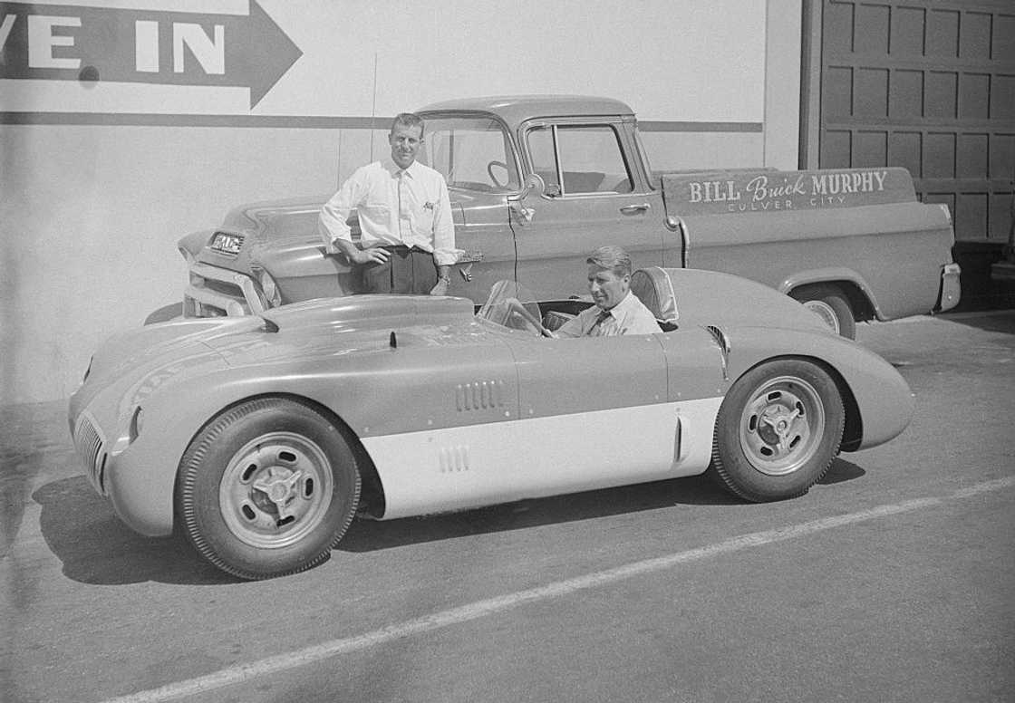 Professional race car driver Sam Hanks (standing) looks over the vehicle built for Bill Murphy Professional race car driver Sam Hanks (standing) looks over the vehicle built for Bill Murphy