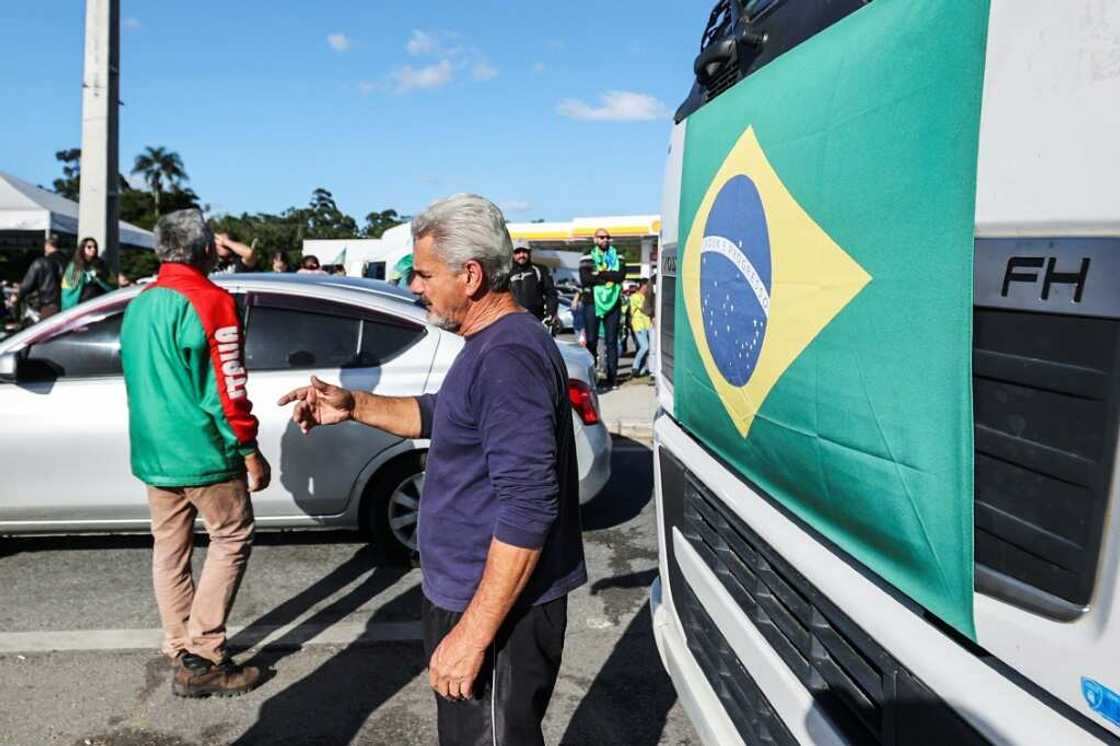 Supporters of Brazilian President Jair Bolsonaro at a road blockade after his election defeat Supporters of Brazilian President Jair Bolsonaro at a road blockade after his election defeat