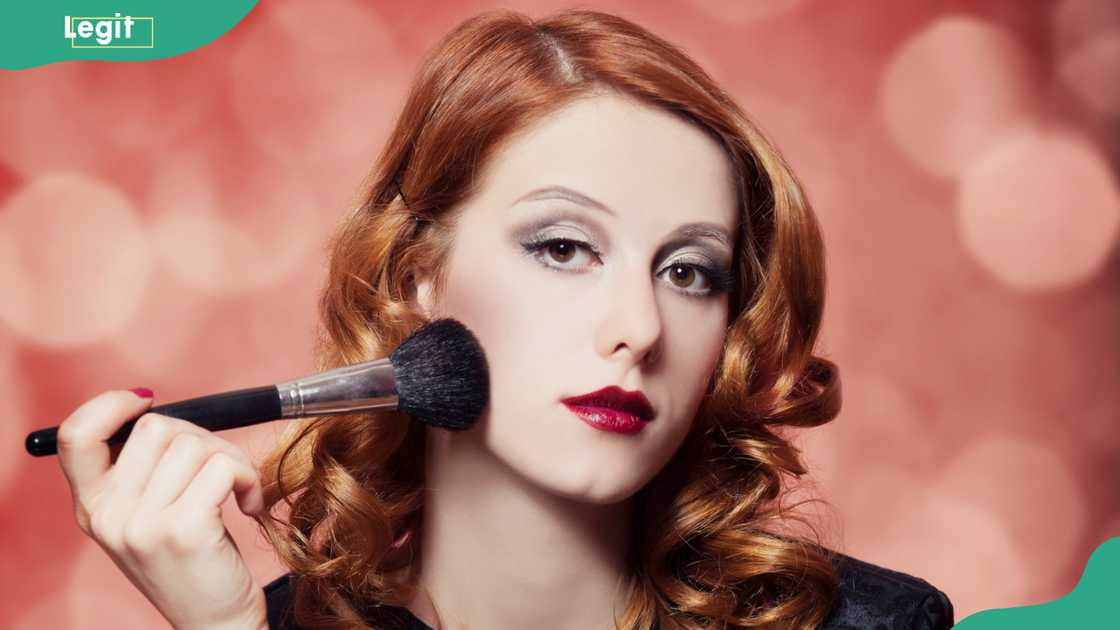 Woman applying makeup Woman applying makeup