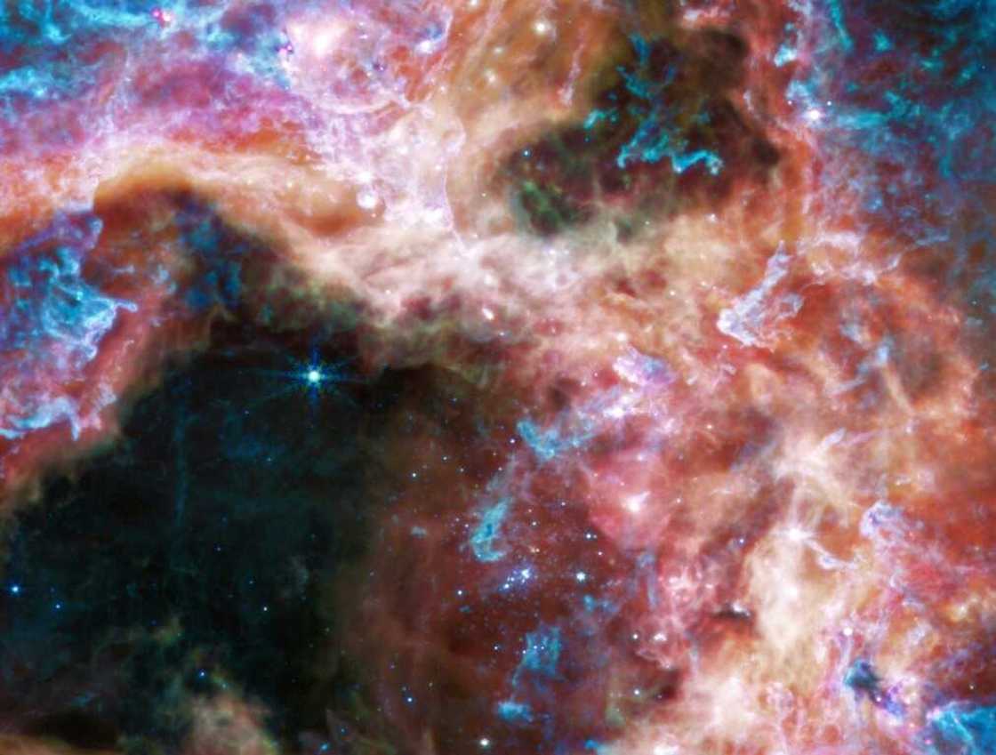 The region was also imaged using the Mid-infrared Instrument (MIRI), which uses longer wavelengths of infrared to pierce through dust grains that absorb or scatter shorter wavelengths The region was also imaged using the Mid-infrared Instrument (MIRI), which uses longer wavelengths of infrared to pierce through dust grains that absorb or scatter shorter wavelengths