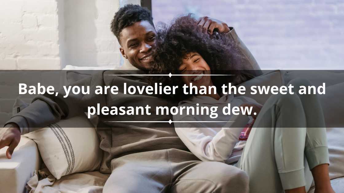 A happy couple is cuddling on a beige sofa A happy couple is cuddling on a beige sofa