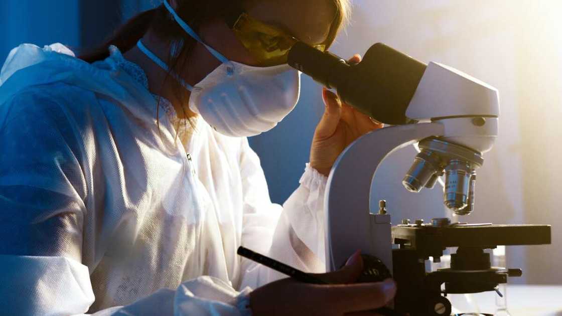 A student looking through a microscope