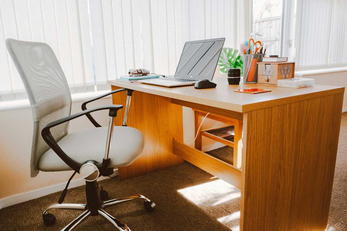 An office desk with a laptop and an office chair