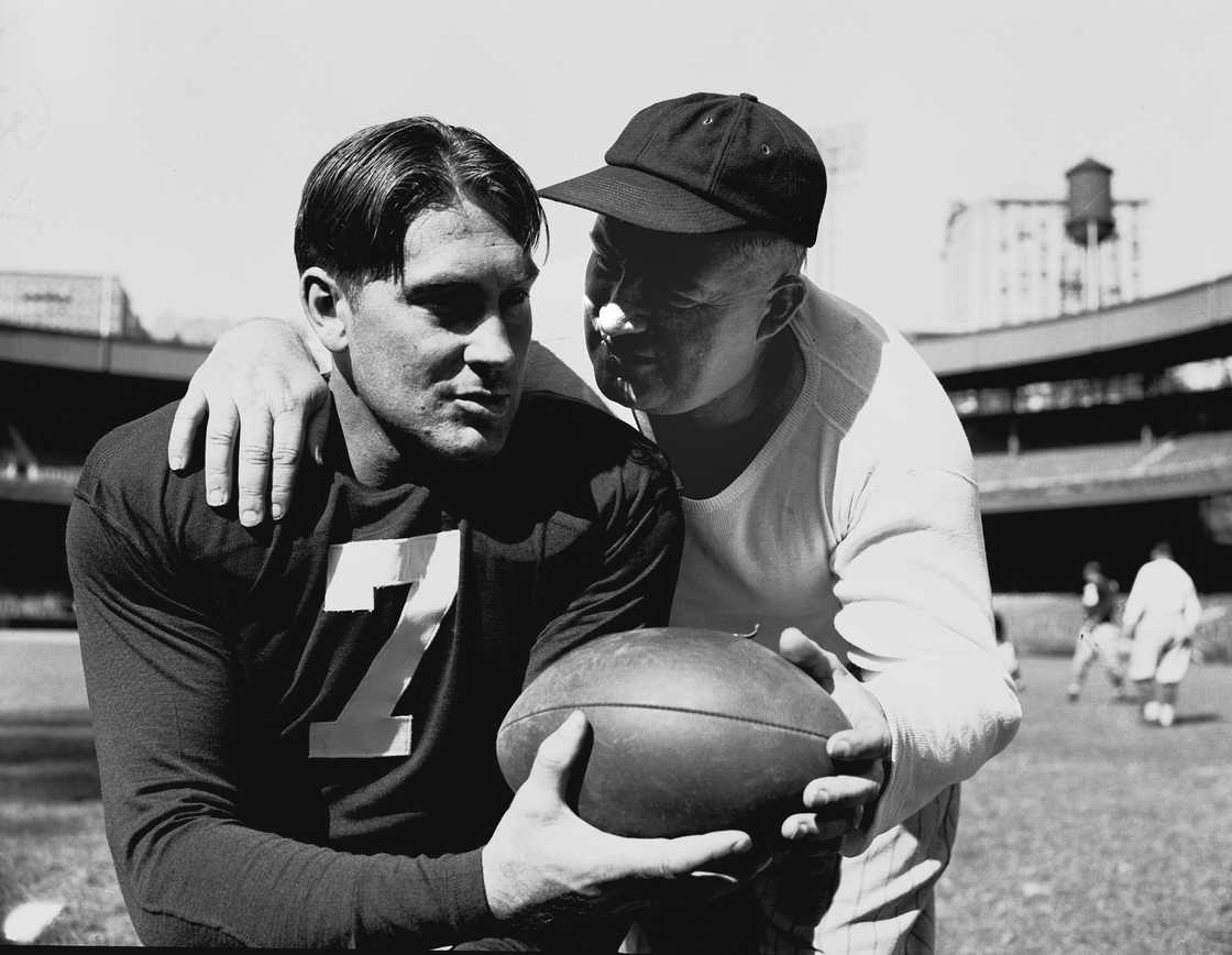 Mel Hein consults his coach Steve Owen