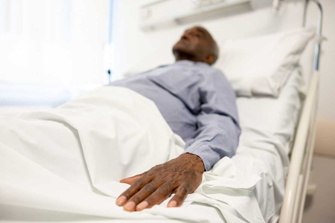A man lying in a hospital bed