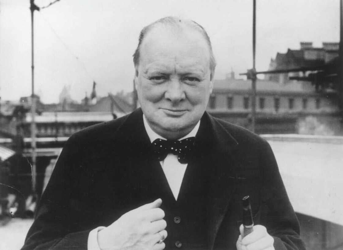 A black and white photo of Winston Churchill in a black suit and a white shirt A black and white photo of Winston Churchill in a black suit and a white shirt