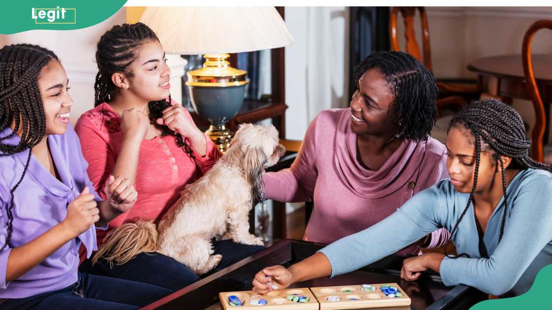 Four ladies playing a game indoors