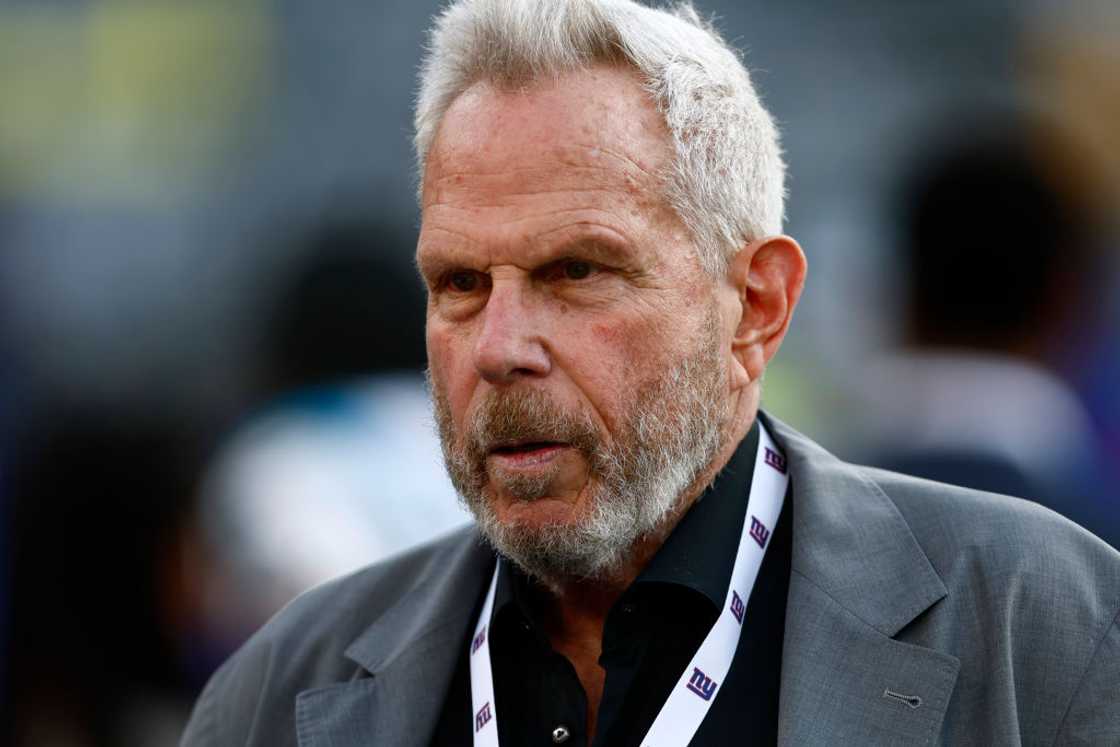 Steve Tisch looks on before the pre-season football game