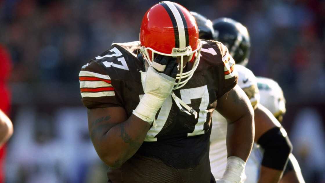 Cleveland Browns offensive lineman Orlando Brown walks off the field holding his injured eye.