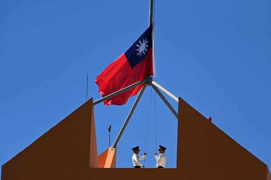 Taiwan's marine corps personnel lowered the island's flag from the roof of Taiwan's embassy in Tegucigalpa on March 26, 2023, as China and Honduras began formal diplomatic relations