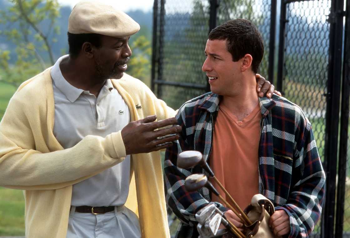 Adam Sandler and Carl Weathers share a conversation on set. Adam Sandler and Carl Weathers share a conversation on set.