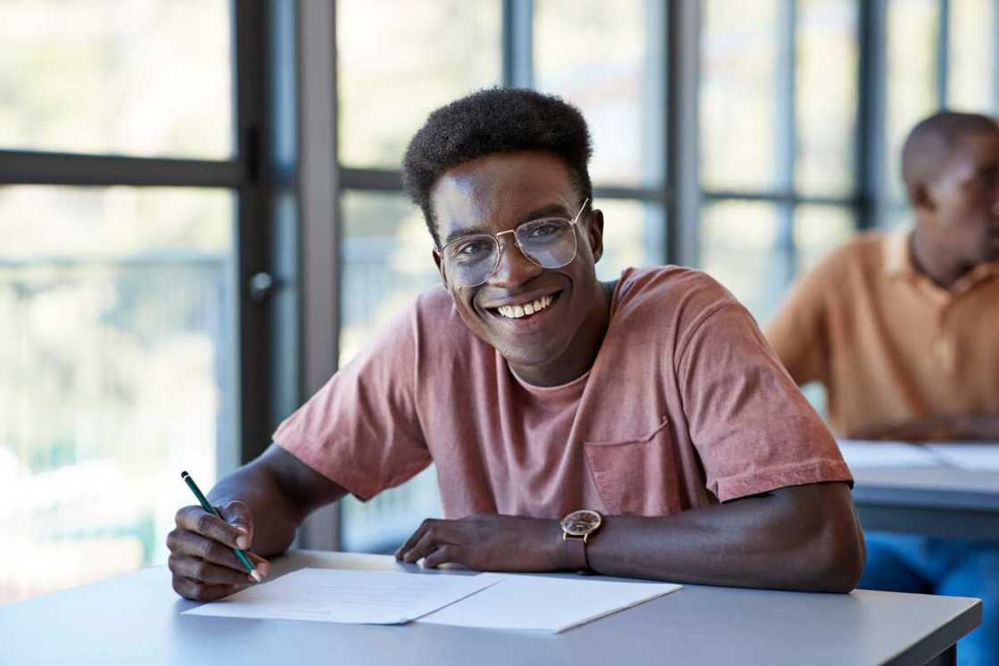 A male student in a classroom A male student in a classroom
