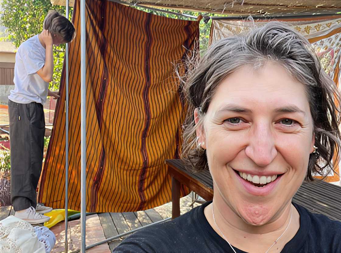Miles Roosevelt Bialik Stone seen in the background with his mother, Mayim Bialik in a backyard Miles Roosevelt Bialik Stone seen in the background with his mother, Mayim Bialik in a backyard