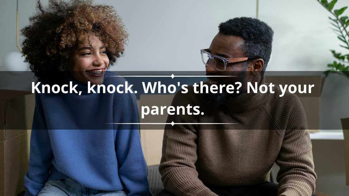 A woman in a blue sweater and a man in a brown sweater are laughing while looking at each other A woman in a blue sweater and a man in a brown sweater are laughing while looking at each other