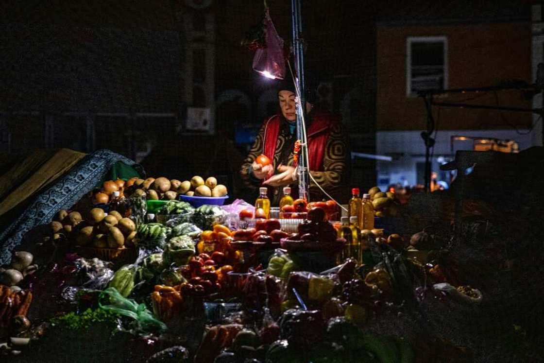 A vendor waits for customers during a power cut at Bessarabsky market in Kyiv A vendor waits for customers during a power cut at Bessarabsky market in Kyiv
