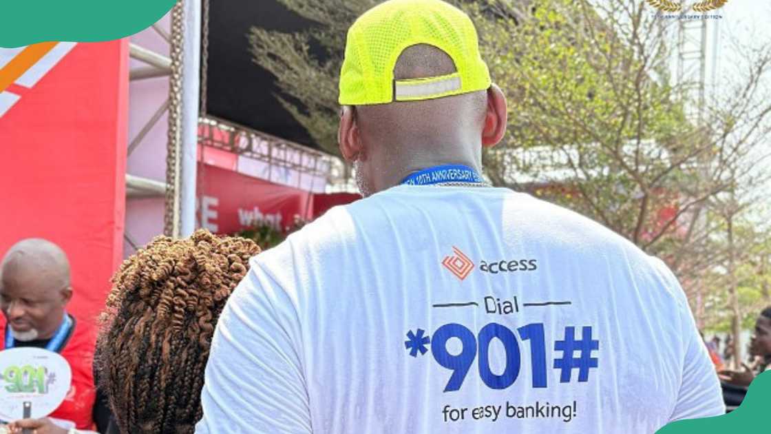 A man wearing a white shirt displaying the Access Bank USSD code. A man wearing a white shirt displaying the Access Bank USSD code.