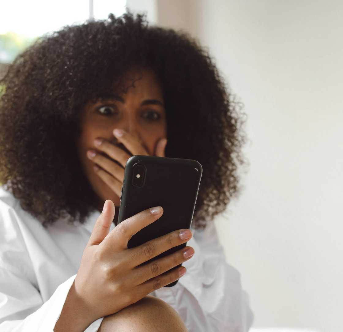 A shocked woman upon looking at a message