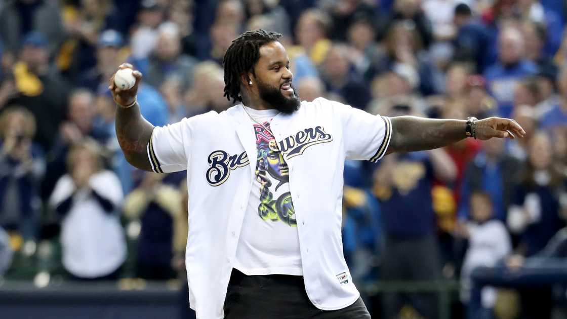 Former baseball player Prince Fielder throws out the first pitch before a game.