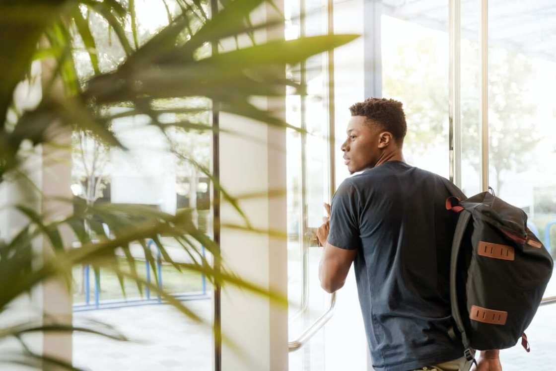 A university student looking through the window A university student looking through the window