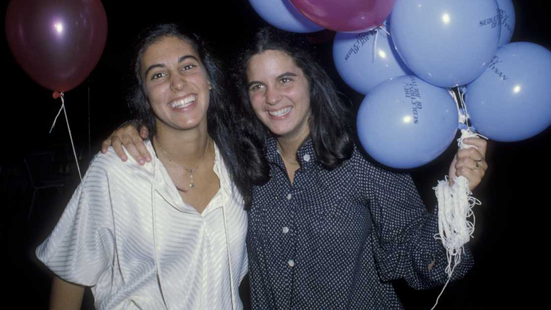 Eve Alda (L) holds her younger sister Elizabeth Alda (R) during her nineteenth birthday party