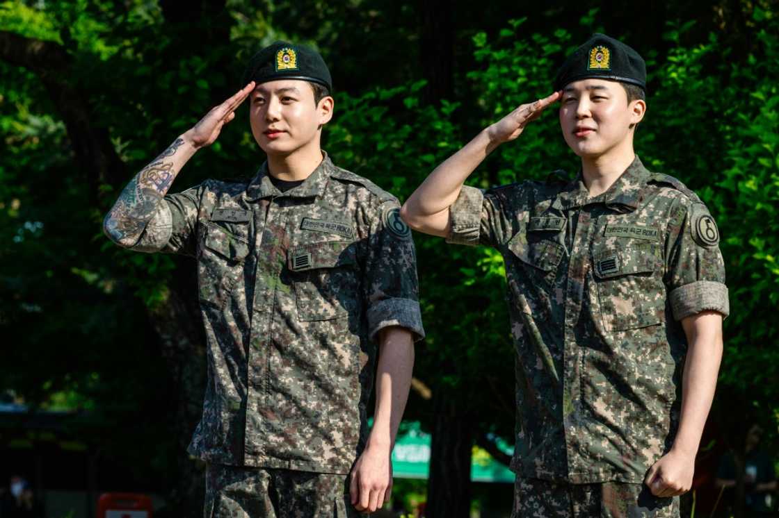 BTS members Jungkook (L) and Jimin (R) salute after their release from South Korean mandatory military service BTS members Jungkook (L) and Jimin (R) salute after their release from South Korean mandatory military service