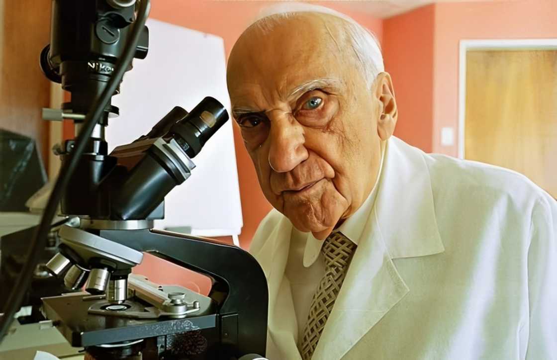 Jacinto Convit poses sitting next to a high-tech microscope Jacinto Convit poses sitting next to a high-tech microscope